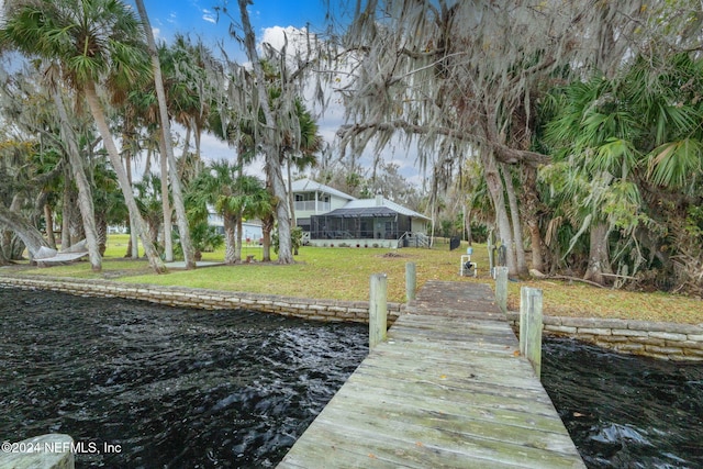 dock area featuring a water view and a yard