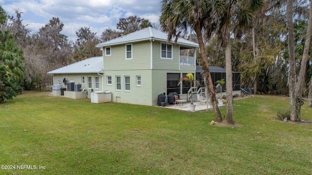 back of house with a balcony, a yard, and a patio