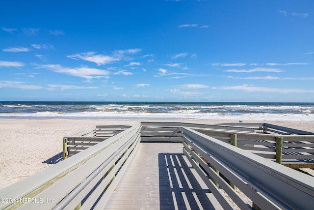 view of home's community with a water view and a view of the beach