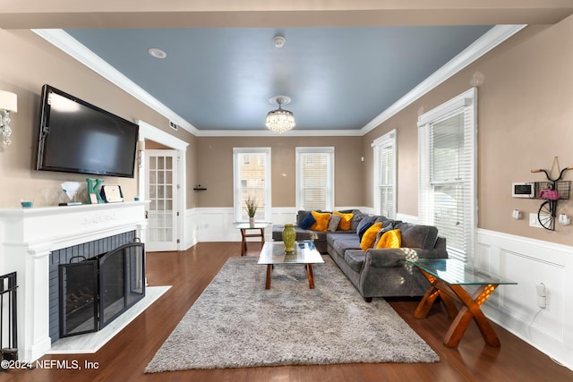 living room with dark wood-type flooring and ornamental molding