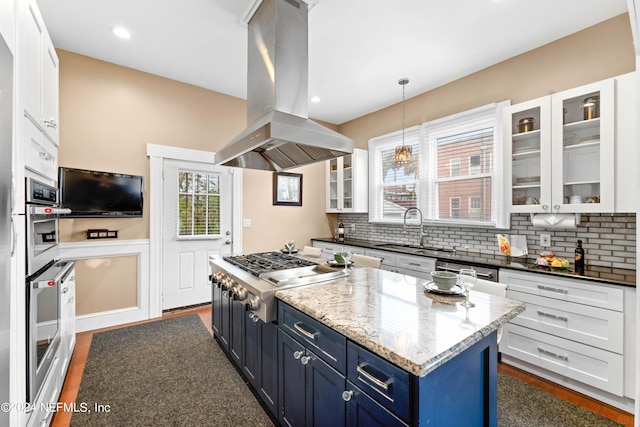 kitchen featuring blue cabinets, sink, white cabinetry, island exhaust hood, and stainless steel appliances