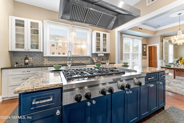 kitchen featuring hardwood / wood-style flooring, white cabinets, range hood, and blue cabinets