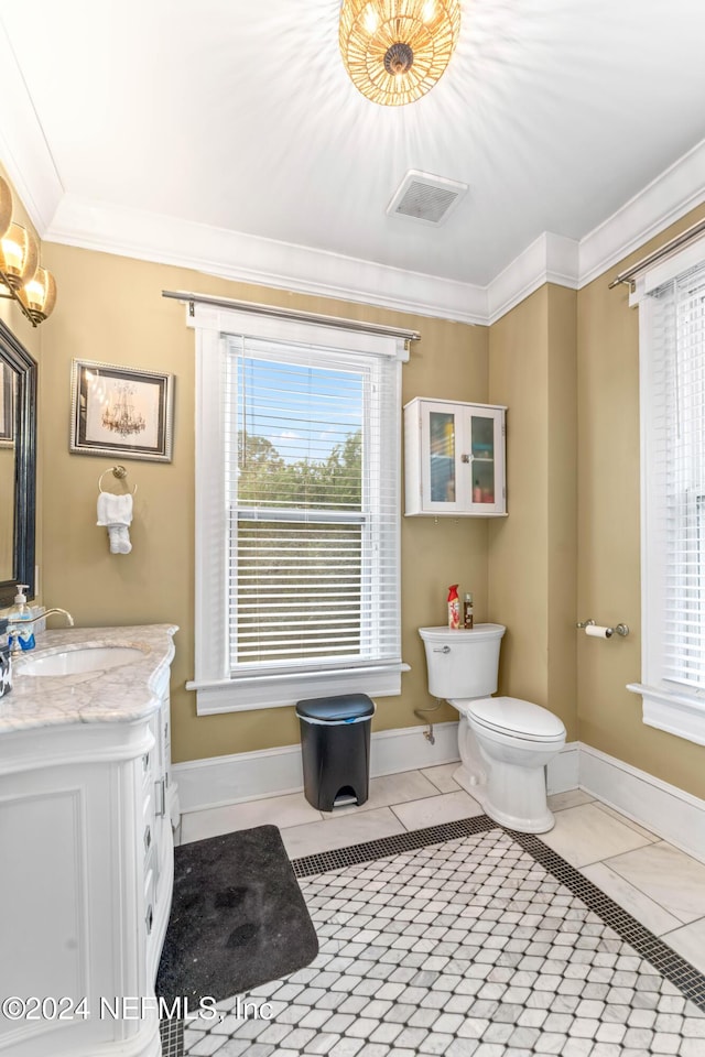 bathroom with tile patterned floors, toilet, vanity, and ornamental molding