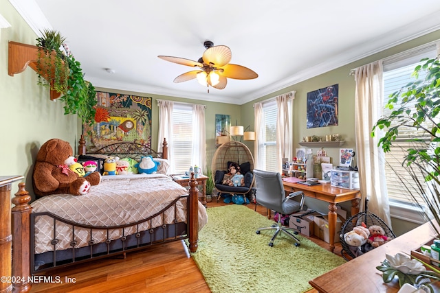 bedroom featuring ceiling fan, hardwood / wood-style floors, and ornamental molding