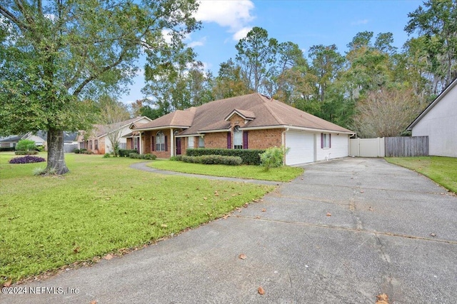 single story home featuring a garage and a front lawn