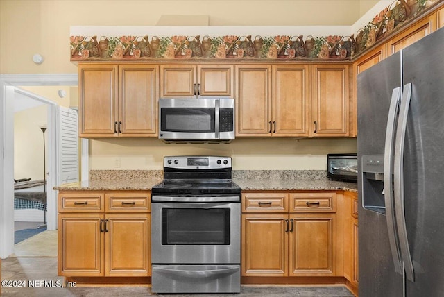 kitchen featuring light stone countertops and appliances with stainless steel finishes