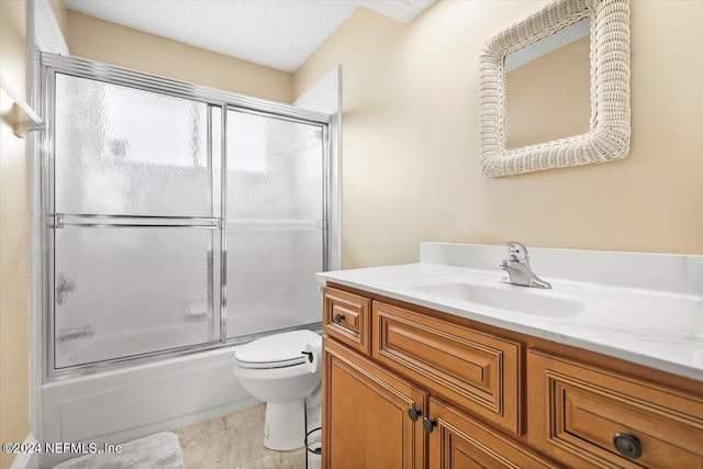 full bathroom with shower / bath combination with glass door, a textured ceiling, vanity, and toilet