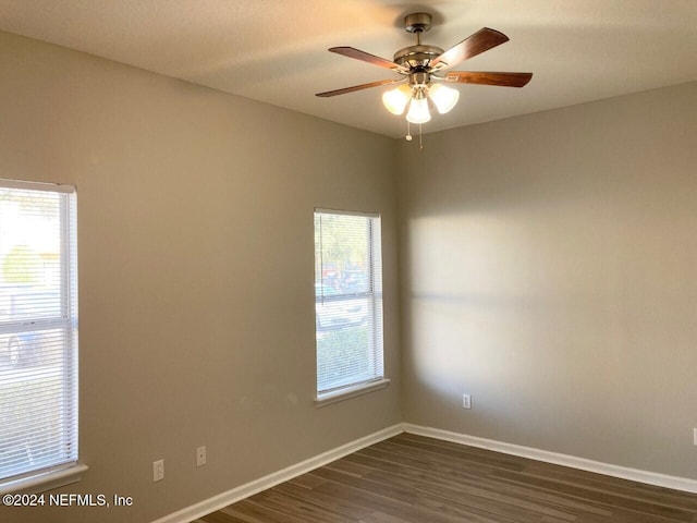 empty room featuring ceiling fan and dark wood-type flooring