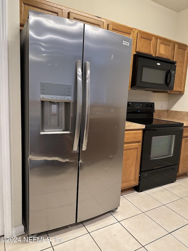 kitchen featuring black appliances and light tile patterned floors