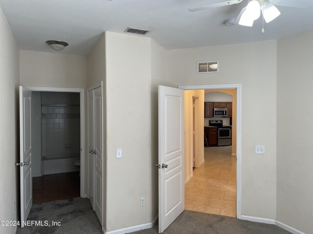 hallway featuring tile patterned flooring