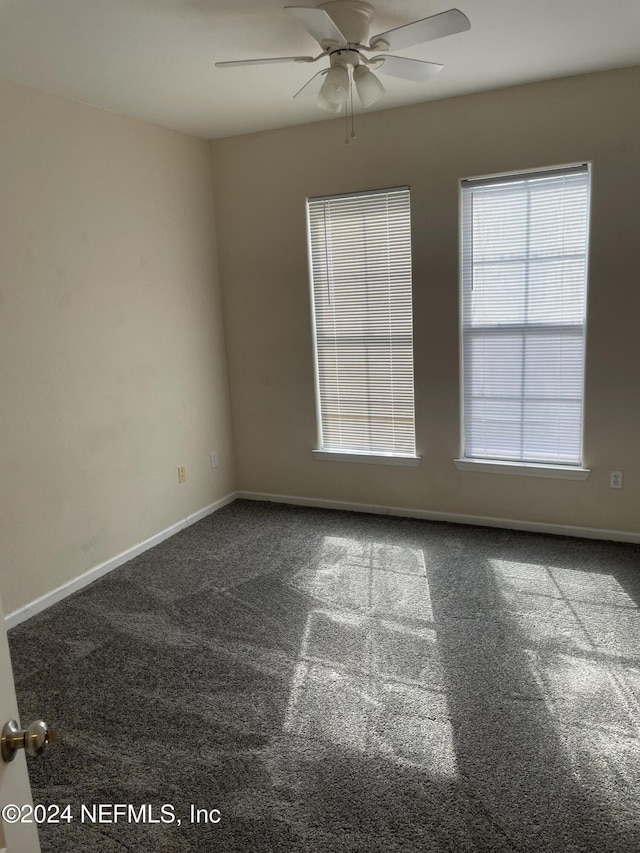 empty room featuring carpet and ceiling fan