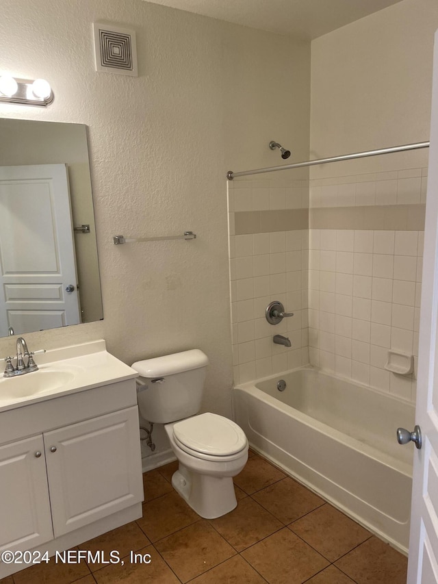 full bathroom featuring tile patterned floors, vanity, toilet, and tiled shower / bath