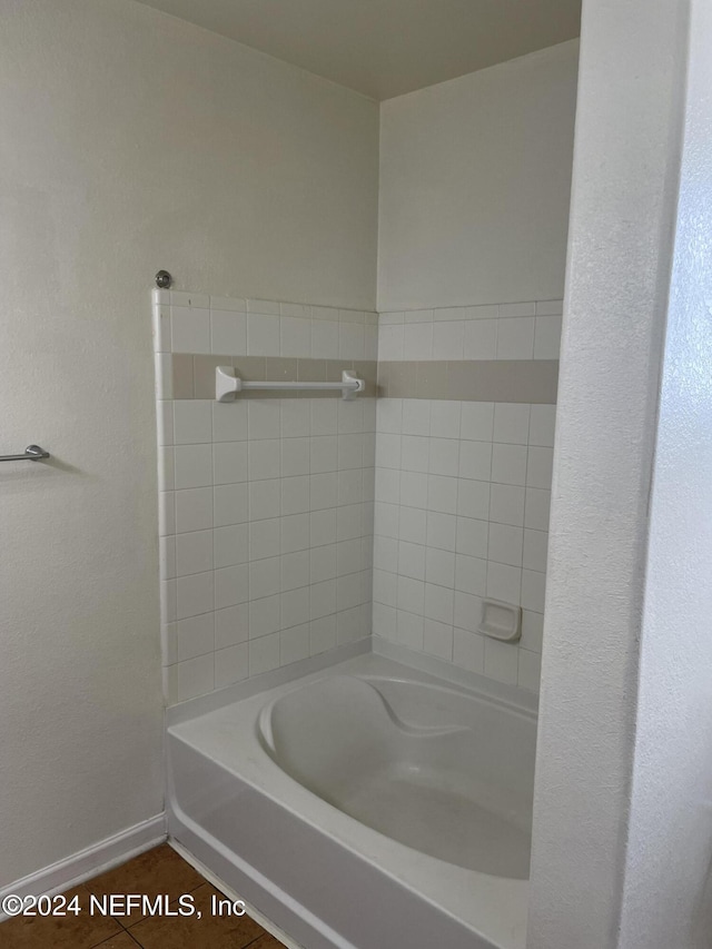 bathroom featuring tile patterned floors and a tub