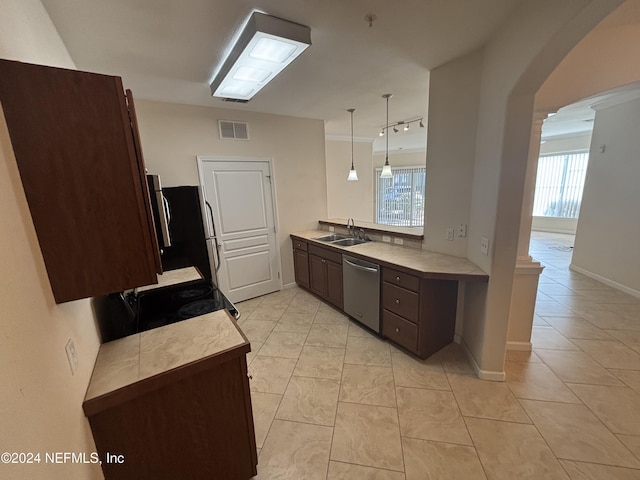 kitchen featuring pendant lighting, sink, light tile patterned floors, and stainless steel appliances