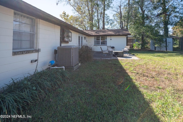 view of yard with a patio, a shed, and cooling unit