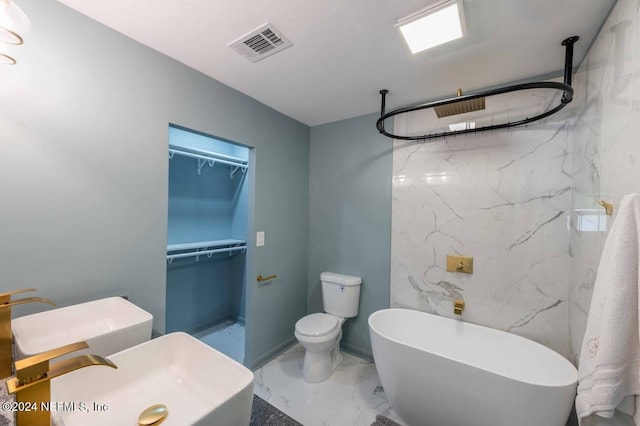 bathroom with toilet, sink, and a washtub