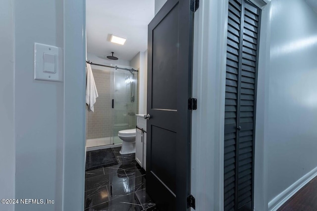 bathroom featuring an enclosed shower and toilet