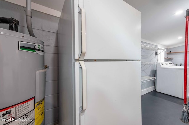 utility room featuring water heater and independent washer and dryer