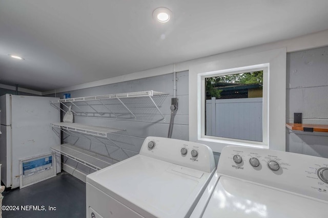 clothes washing area featuring independent washer and dryer