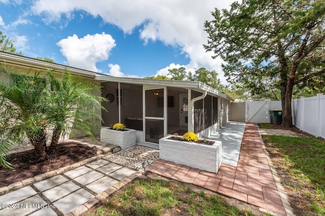 back of house featuring a sunroom