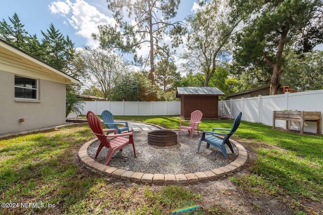 view of patio / terrace with a storage shed and an outdoor fire pit