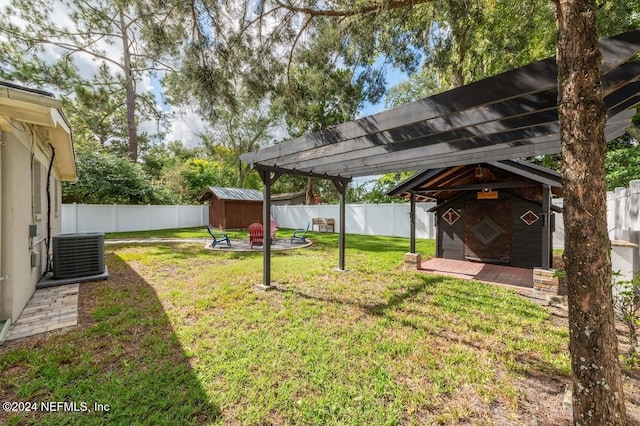 view of yard with cooling unit, a storage shed, and a pergola