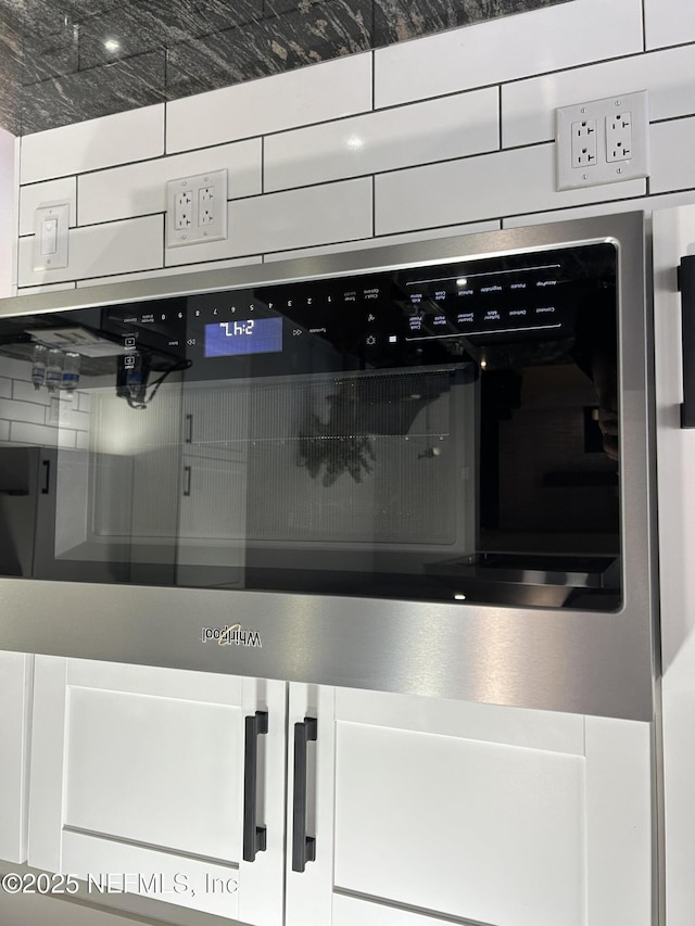 details with wall oven and white cabinets