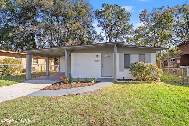 view of front of property featuring a front lawn and a carport