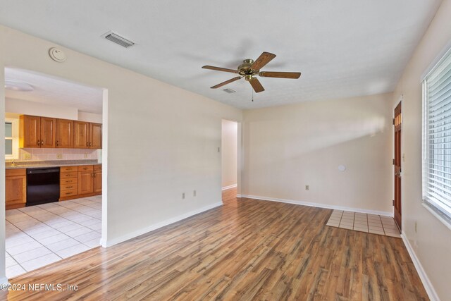 unfurnished room with ceiling fan and light hardwood / wood-style flooring