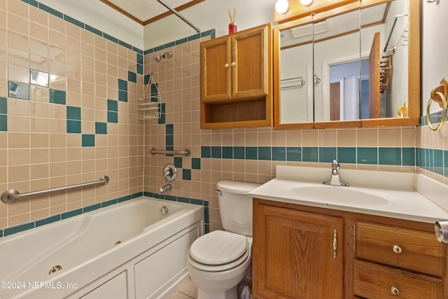 full bathroom featuring vanity, tiled shower / bath, toilet, tile walls, and tasteful backsplash