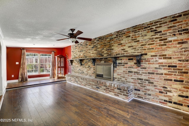 unfurnished living room featuring baseboards, a textured ceiling, a ceiling fan, and hardwood / wood-style flooring