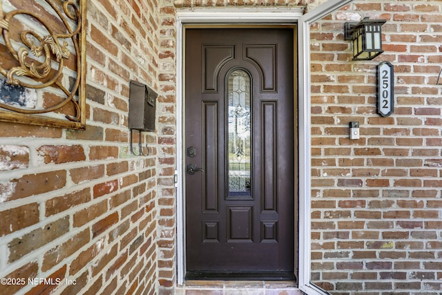 entrance to property with brick siding