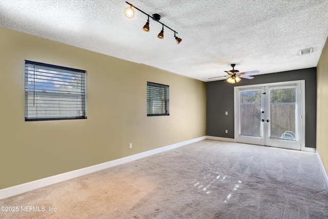 spare room with french doors, baseboards, visible vents, and carpet flooring