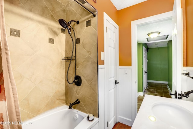 full bathroom with a wainscoted wall, a textured ceiling, vanity, and shower / bath combination with curtain