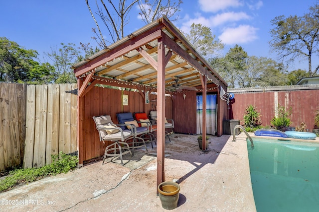 view of patio featuring a jacuzzi and a fenced backyard