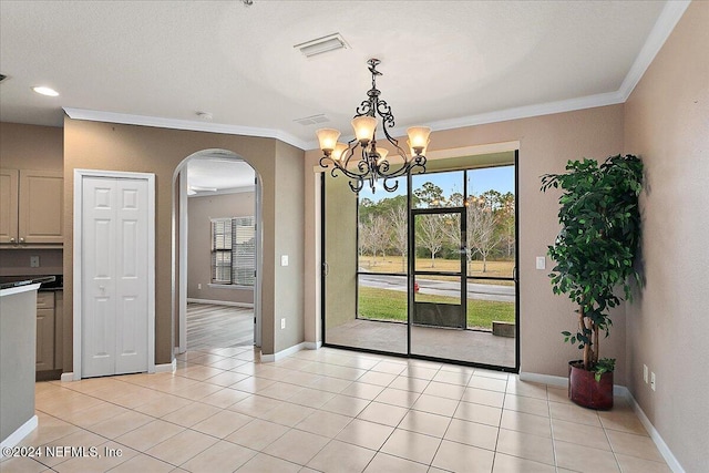 unfurnished dining area featuring light tile patterned floors, crown molding, and a notable chandelier