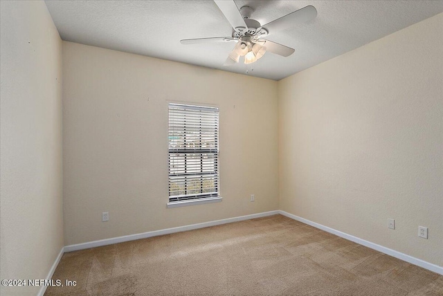 unfurnished room with ceiling fan and light carpet