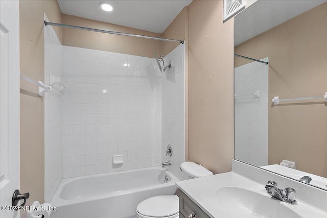 full bathroom with toilet, vanity, and tiled shower / bath