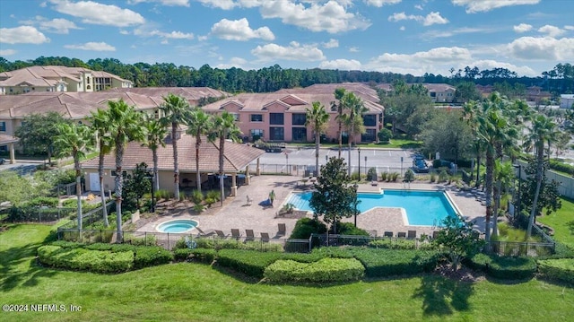 view of swimming pool with a lawn