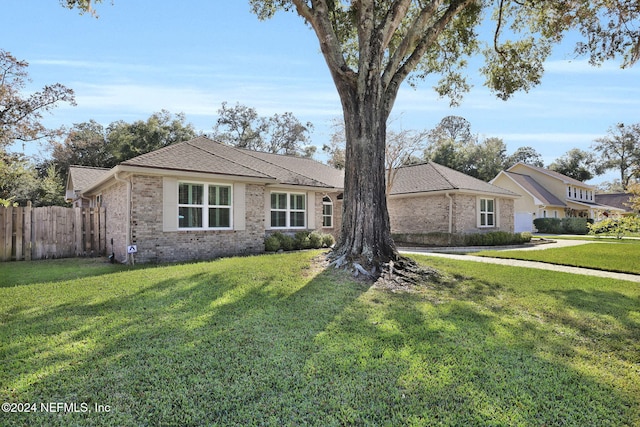 single story home featuring a front yard