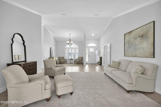 living room with crown molding, a chandelier, and vaulted ceiling