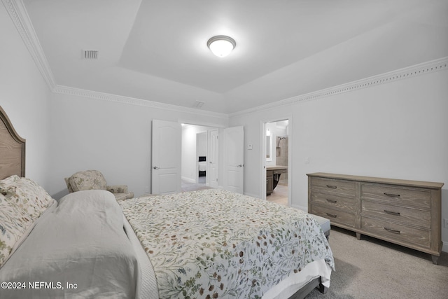 carpeted bedroom featuring ensuite bathroom and ornamental molding