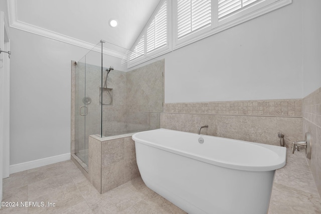 bathroom with ornamental molding, tile patterned floors, separate shower and tub, and lofted ceiling