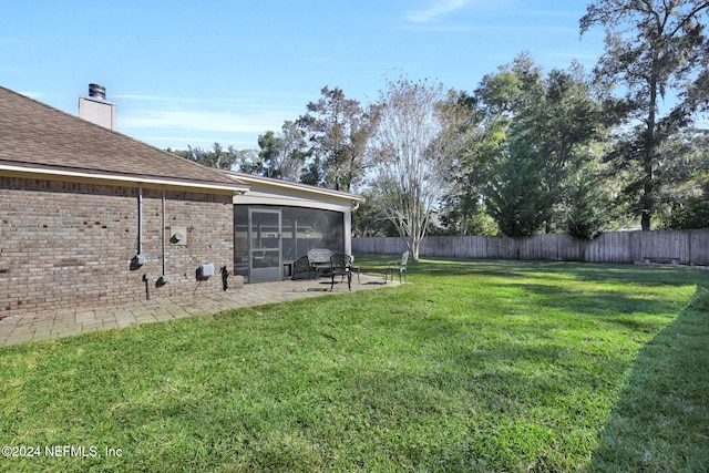 view of yard featuring a patio area and a sunroom