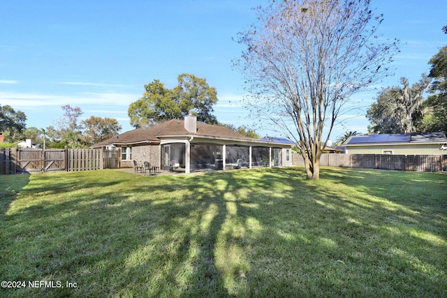 view of yard featuring a sunroom and a patio area