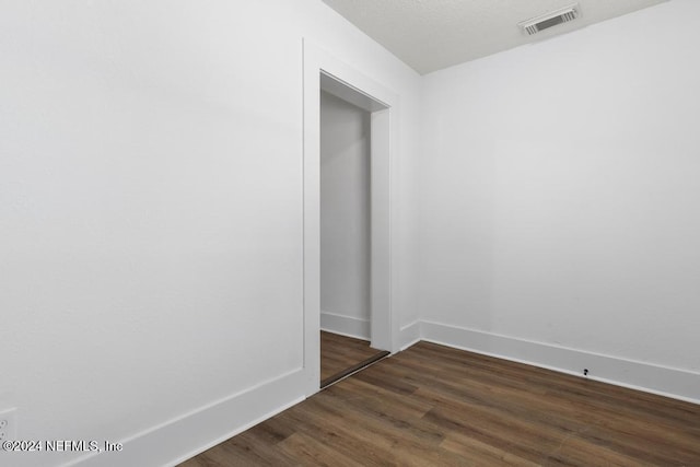 spare room with dark hardwood / wood-style flooring