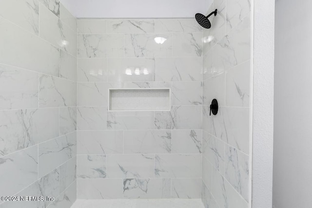 bathroom with tiled shower