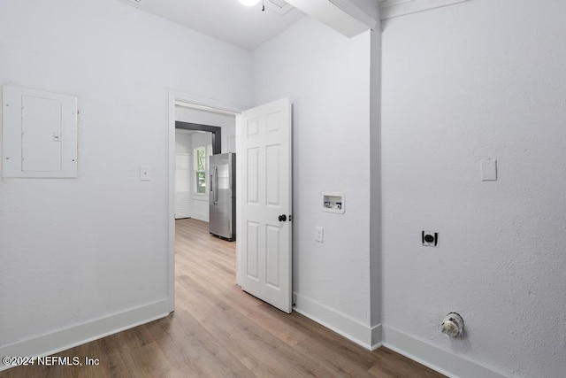 corridor featuring electric panel and light wood-type flooring