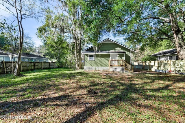 back of house featuring a yard