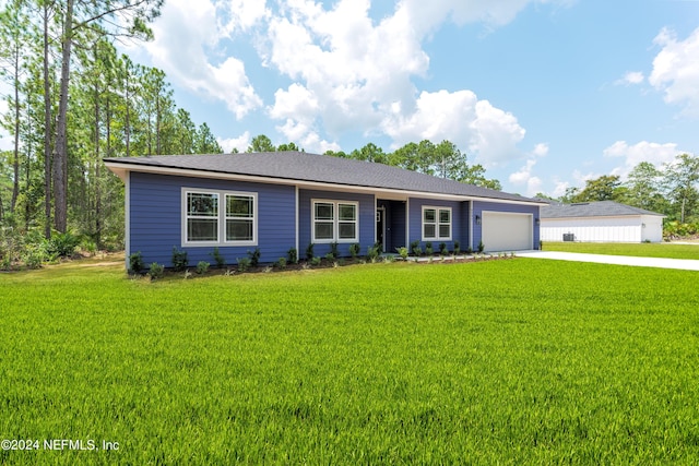 ranch-style home featuring a garage and a front lawn